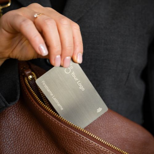 Black Metal NFC Business Card Grey Brush being pulled out of a suit pocket