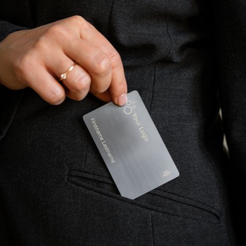 Brushed Metal Grey NFC Business Card being pulled out of a suit pocket