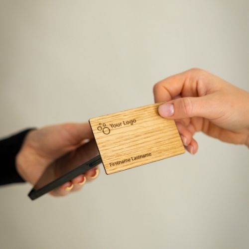 NFC Business Card Oak Wood being tapped by a mobile phone
